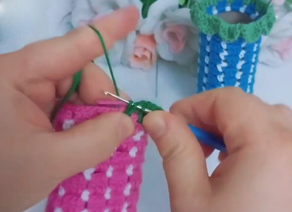 Adding green trim onto pink jar