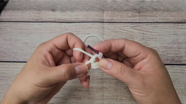 crocheting a magic ring center with white yarn