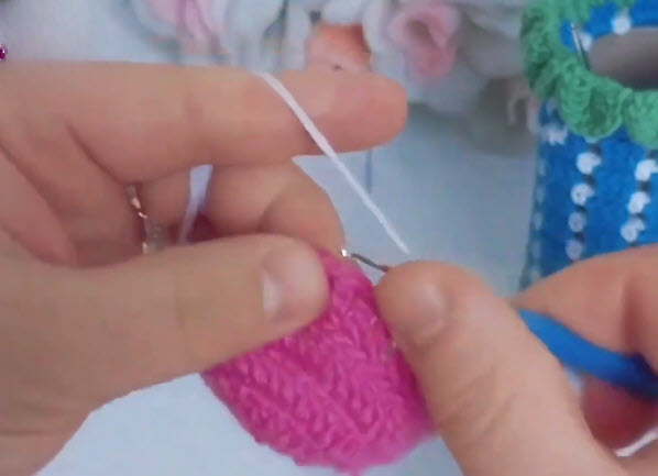 Crocheting pink stitches with hook