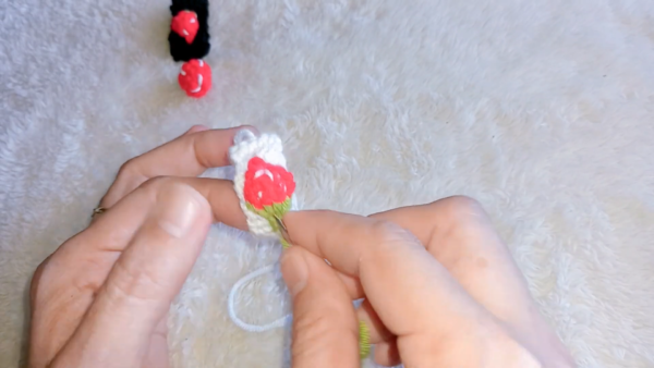 Red strawberry piece on black strap