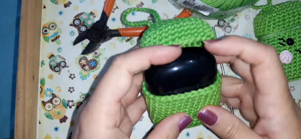 Attaching eye button on crochet airpods case