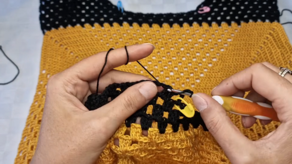 Black trim row on granny square crochet tank top