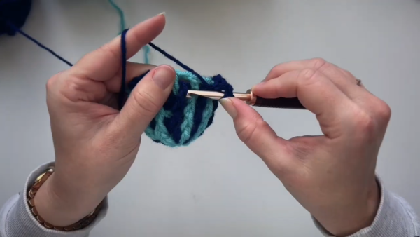 Continuing rounds with navy blue yarn