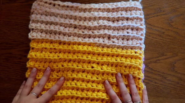 Cream and yellow crochet squares with random color changes.