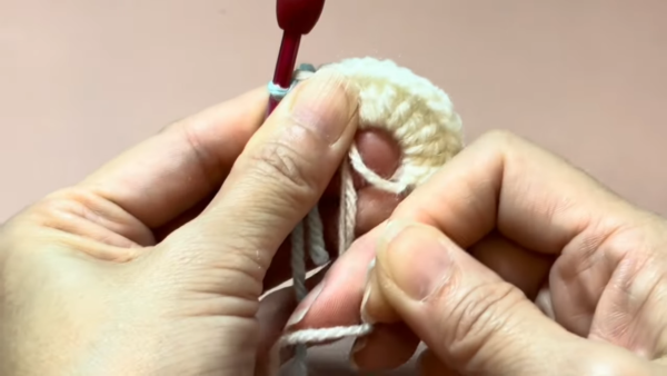 Crocheting cream amigurumi owl body piece