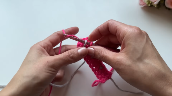 Crocheting pink and gray stitches