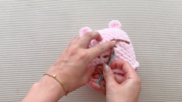Embroidering face on crochet toy