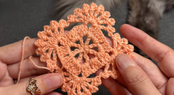 Finished crochet coaster motif with scalloped border