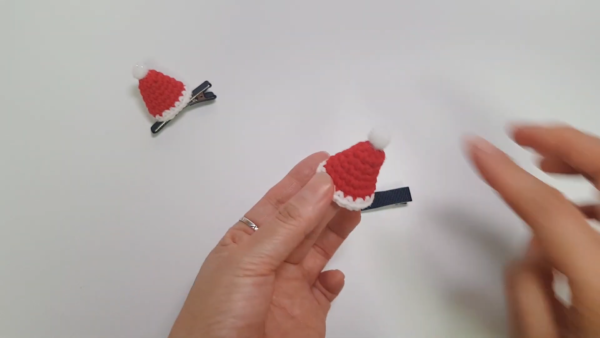 Finished crochet santa hat clips displayed together