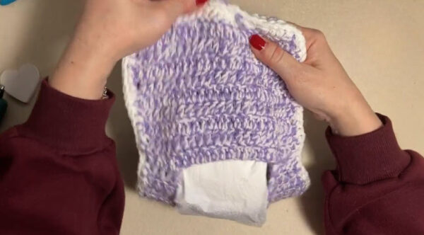 Finished purple and white crochet toilet paper roll cover
