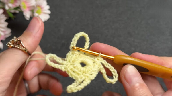 Forming petal loops around crochet flower motif