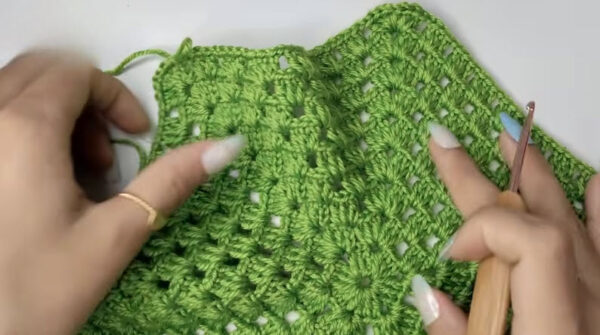 Green granny stitch panel being worked with a hook.