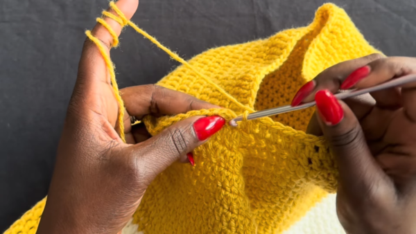 Hook through turtleneck poncho collar seam