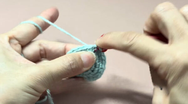 Increase round on light blue amigurumi owl body