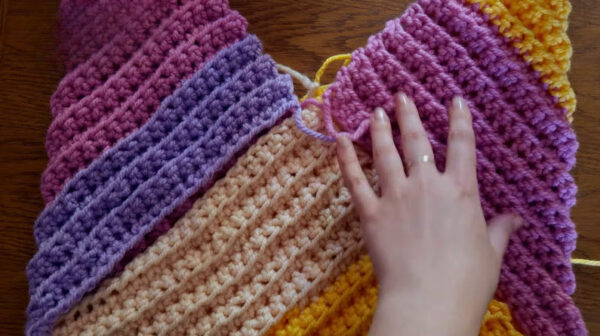 Pink and purple triangles joined with slip stitch seams.