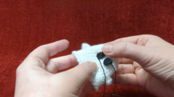 Sewing eyes onto finished ghost tea light cover