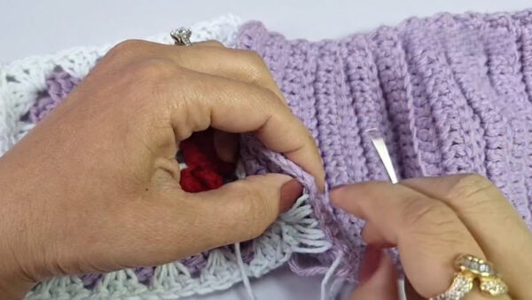 Sewing purple panels together by hand