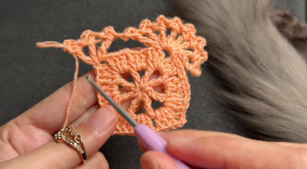 Square crochet motif taking shape with picot edging