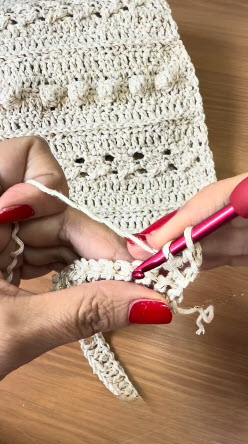 Working bobble stitch row on crochet Cala blouse