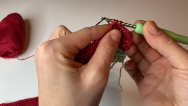 Working single crochet in red yarn