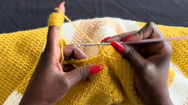 Yarn wrapped on finger for tension