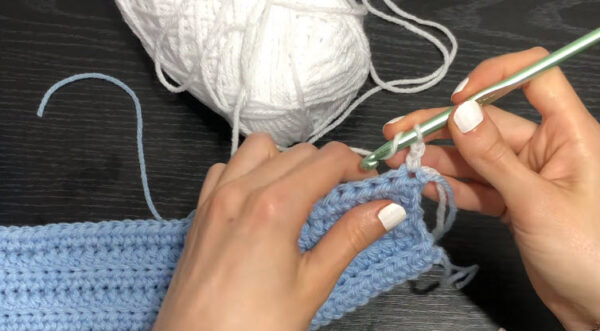 Attaching white yarn to a light blue crochet row
