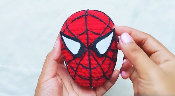 Finished Spider-Man style red crochet mask with white eyes for the crochet Spider-Man keychain
