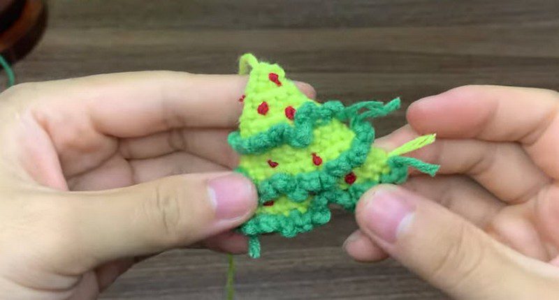 Finished tiered green tree with ruffled edges and small red dots.