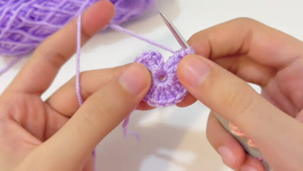 Folding the circle to start shaping the first ear.