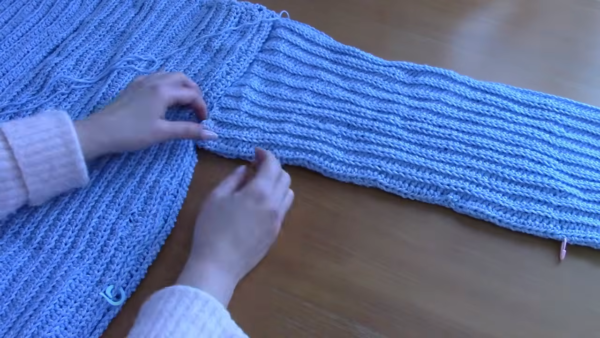 Fully assembled light blue ribbed crochet cardigan.