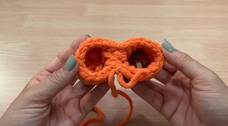 Join both legs with orange yarn to start the body.