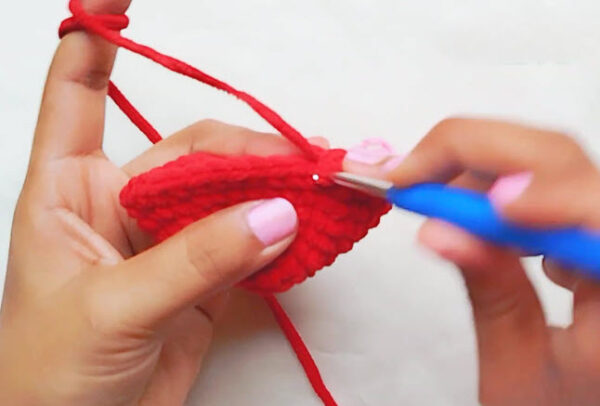 Crochet Spider-Man keychain step: red piece widening into a rounded shape