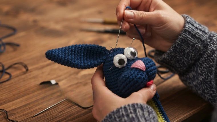 Eyes and pink nose sewn onto the bunny face