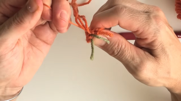 Starting the magic ring with orange yarn