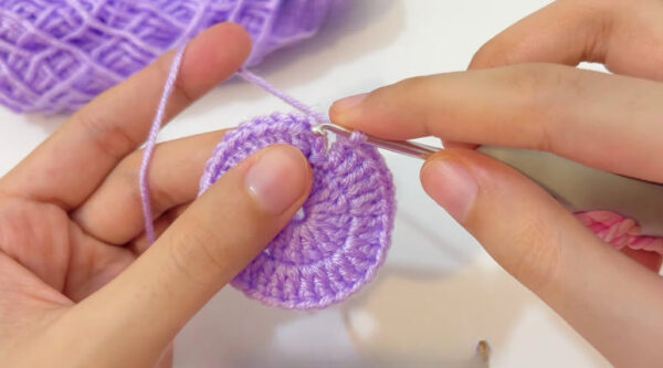 Working a round on the purple circle with a silver hook.