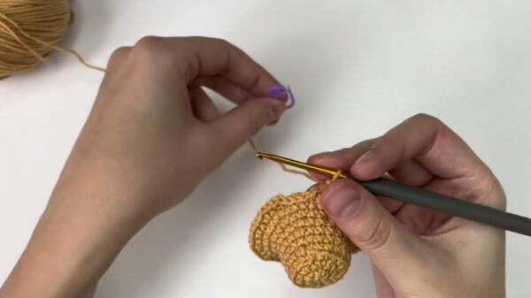 Working slip stitches around the brim edge.